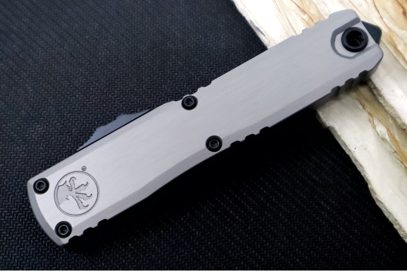 Microtech Ultratech ZBP (Zero Blade Play) OTF - Black Finish / Single Edge with Partial Serrate / Natural Clear Anodized Aluminum Handle 1121-2NC