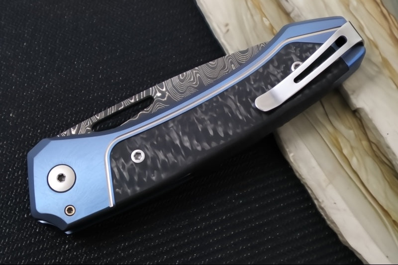 Lionsteel Twain Solid Button Lock Folder - Drop Point Blade / Scrambled Chad Nichols Damascus Steel / Blue Titanium Handles with Integral Carbon Fiber Inlay TW-D-BL