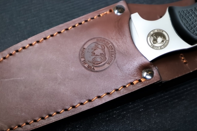 Knives of Alaska Bush Camp Fixed Blade - Black Surgrip Handle / D2 Tool Steel / Drop Point Blade / Brown Leather Sheath 00014FG