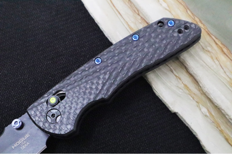 Hogue Knives Deka Collector Series - Black Cerakote Finish / Clip Point Blade / Carbon Fiber Handle / Green Tritium Axis Lock 24299-LIM