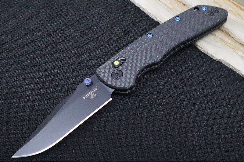 Hogue Knives Deka Collector Series - Black Cerakote Finish / Clip Point Blade / Carbon Fiber Handle / Green Tritium Axis Lock 24299-LIM