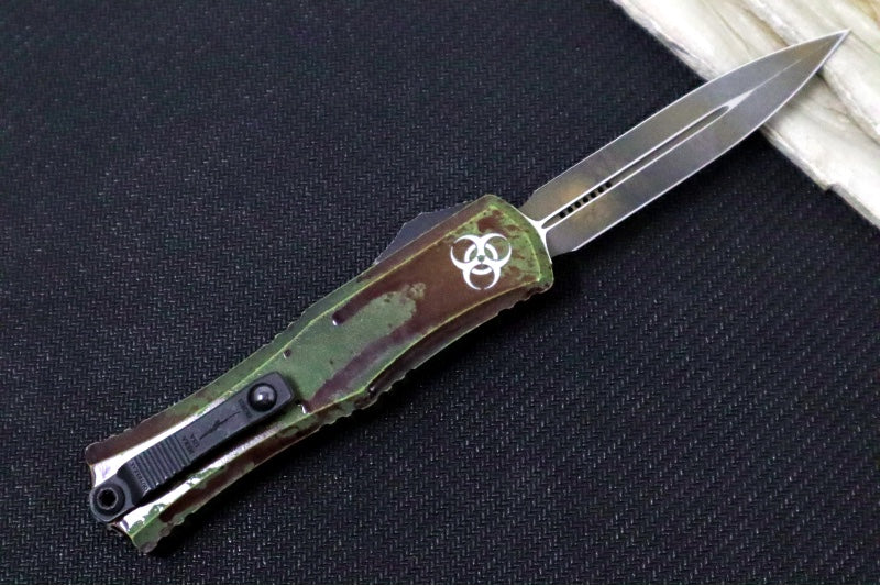 Microtech Mini Hera II Outbreak OTF - Dagger Blade / Dark Apolcoplyptic Finish / Outbreak Green Anodized Aluminum Handle with Blood Splatter / Deep Engraved Biohazard Symbol 1702M-1OBDS