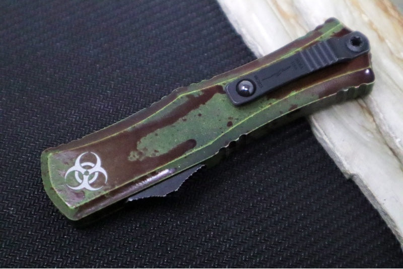 Microtech Mini Hera II Outbreak OTF - Dagger Blade / Dark Apolcoplyptic Finish / Outbreak Green Anodized Aluminum Handle with Blood Splatter / Deep Engraved Biohazard Symbol 1702M-1OBDS