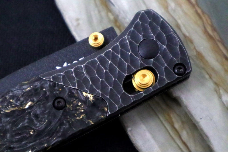 Benchmade 535 Bugout Gold Class - Titanium Hammered Bolster & Fatcarbon Steller Handle Onlay / M390 Steel / Drop Point Blade with Black Cerakote / Last Chance Gulch MT Blade Engraving / Gold Plated Backspacer & Thumb Stud