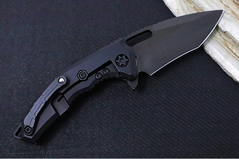 Heretic Knives Medusa Manual Flipper - Recurve Blade / CPM-Magnacut Steel / Black Anodized Aluminum Handle with Black Grip-Tape Inlays / Black Tactical DLC Finished Blade and Hardware H010-6A-T