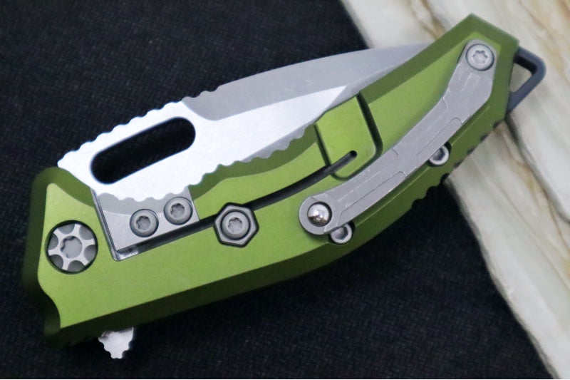 Heretic Knives Medusa Manual Flipper - Tanto Blade / CPM-Magnacut Steel / OD Green Anodized Aluminum Handle with Black Grip-Tape Inlays / Battleworn Finished Blade and Hardware H009-5A-GRN - Northwest Knives