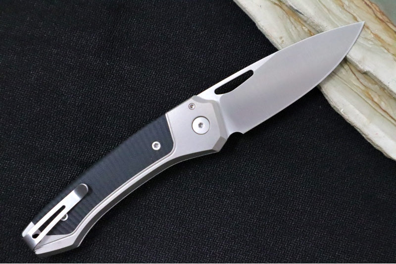 Lionsteel Twain Solid Button Lock Folder - Drop Point Blade / CPM-Magnacut Steel / Gray Titanium Handles with Integral Black G-10 Inlay TWGYGBK - Northwest Knives