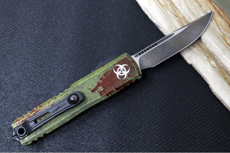 Microtech UTX-85 OTF Gen IV Outbreak Signature Series - Single Edge Blade / Dark Apocalyptic Finish / Green Anodized Aluminum Handle with Blood Splatter 12314-1OBDS - Northwest Knives