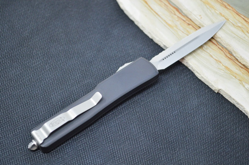 Microtech UTX-70 OTF - Dagger Blade with Full Serrated / Satin Finish / Black Aluminum Anodized Handle 147-6