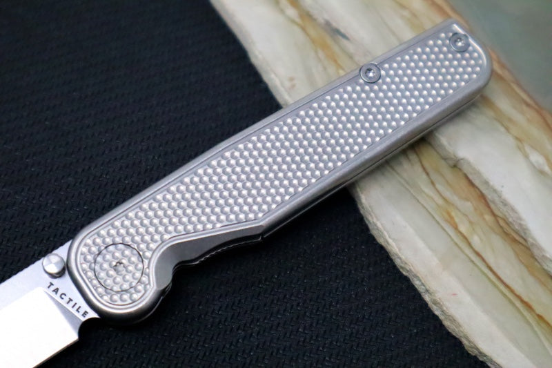 Tactile Turn Rockwall Thumbstud - Textured Titanium Handle / Magnacut Steel / Drop Point Blade